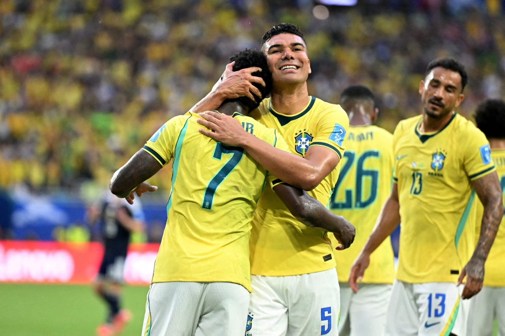 Brazil's #07 Vinicius celebrates with #05 Casemiro second goal. — AFP