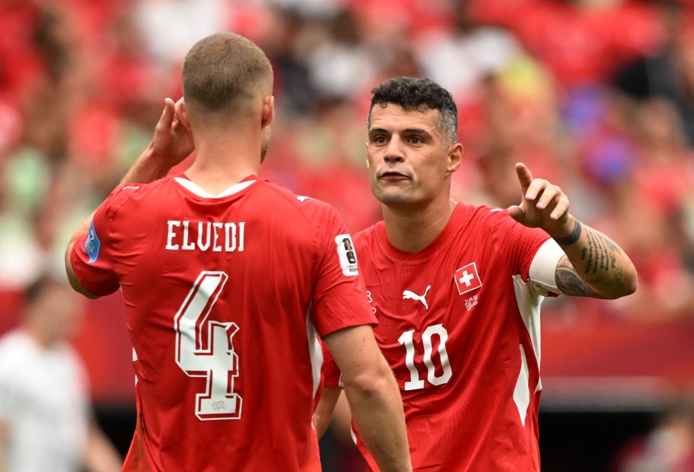  
Switzerland's Xhaka and Nico Elvedi react . — Reuters 