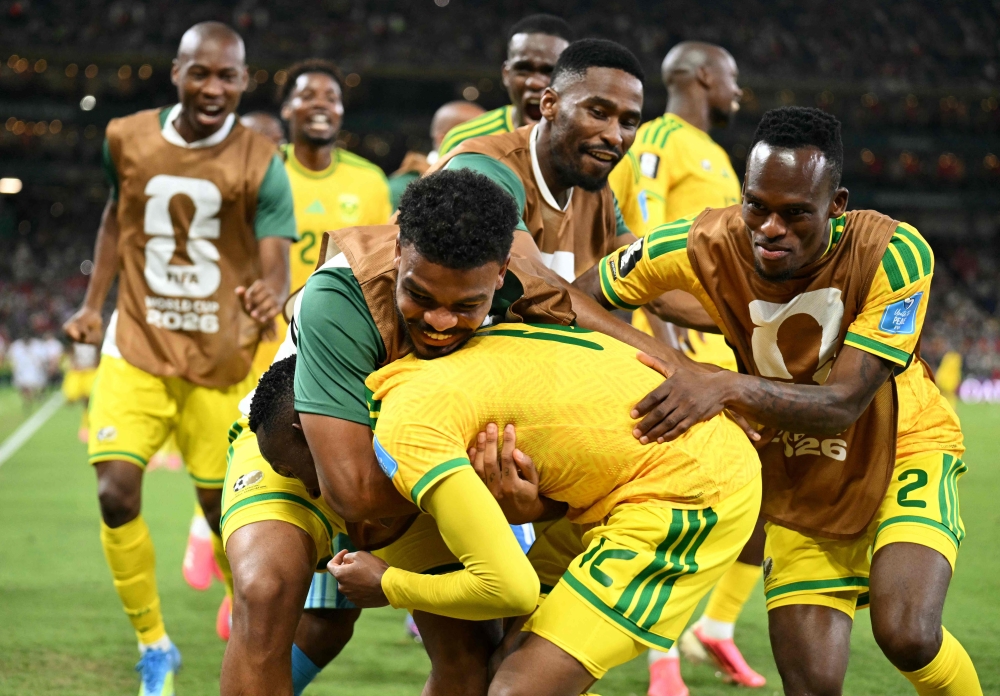 South Africa's #12 Maseko is hugged by teammates. — AFP