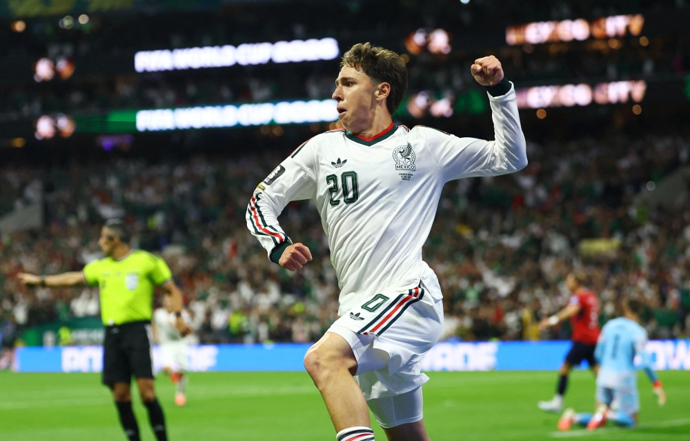   
Mexico's Chavez celebrates scoring their first goal. — Reuters 