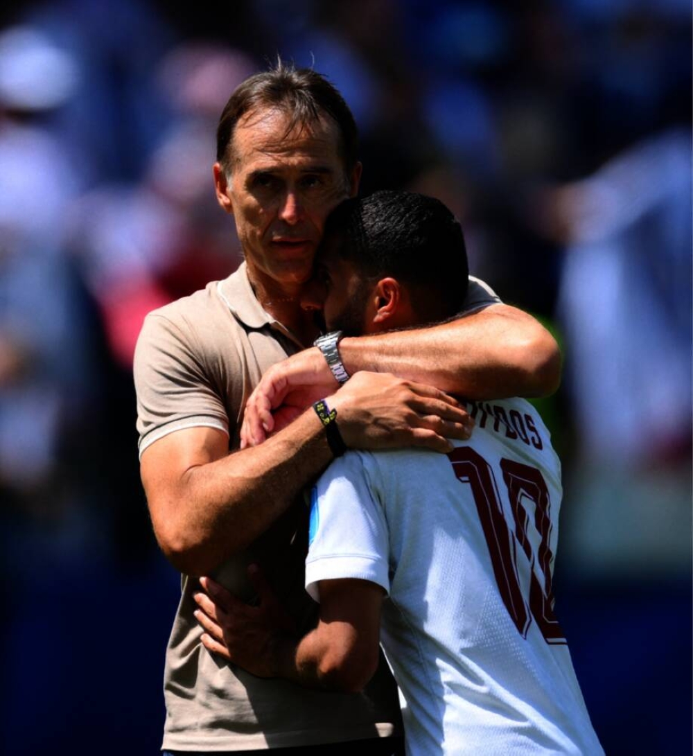  
Qatar's Hassan Alhaydos and coach Julen Lopetegui look dejected after the match  