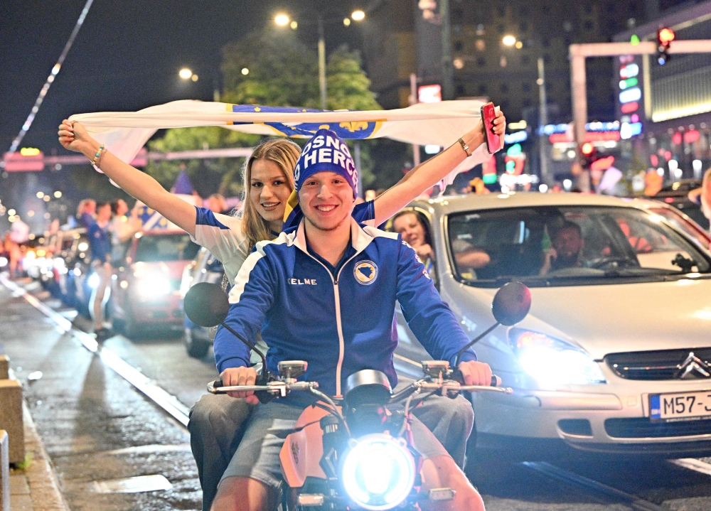 Bosnia and Herzegovina's supporters celebrate in the streets at the end of the Bosnia and Herzegovina World Cup 2026 football match against Qatar 