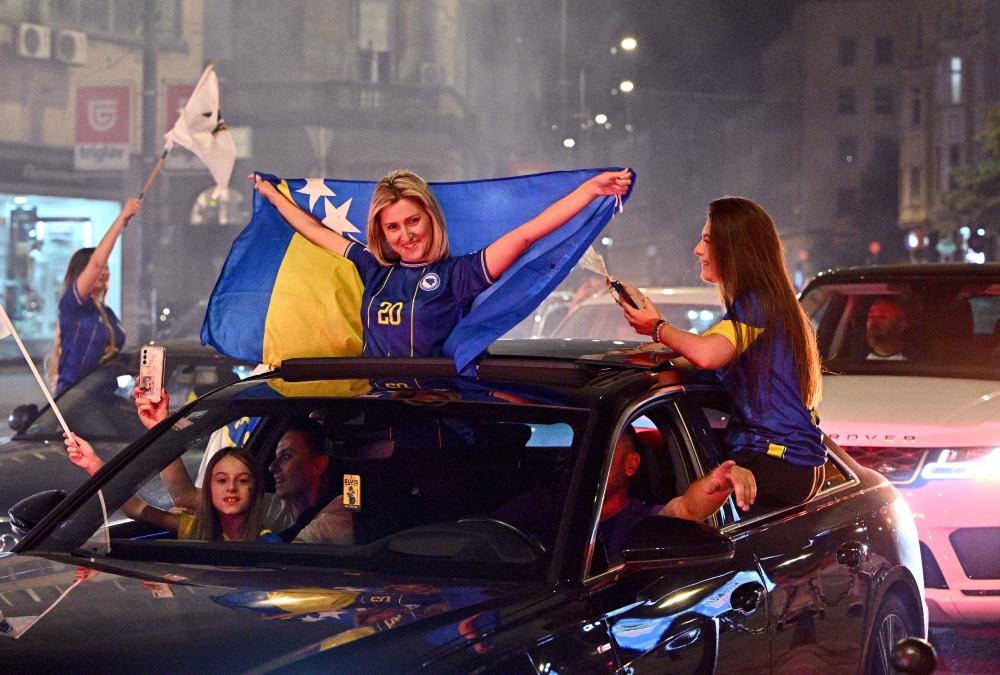 Bosnia and Herzegovina's supporters celebrate in the streets at the end of the Bosnia and Herzegovina World Cup 2026 football match against Qatar  