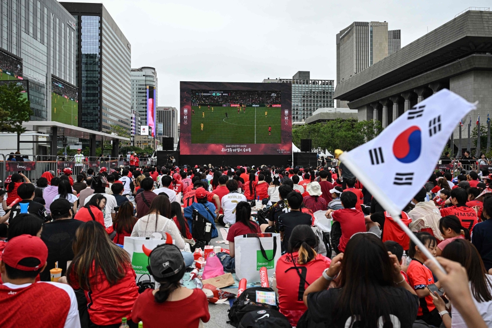 South Korean fans watch the 2026 World Cup football match between South Korea and South Africa on big screens at Gwanghwamun Square  