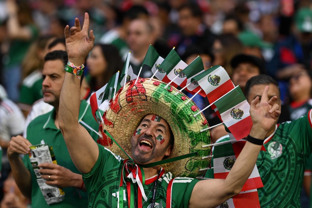 A Mexican fan wearing a hat cheers for his team during the 2026 World Cup Group A football match between the Czech Republic and Mexico at the Mexico City Stadium 