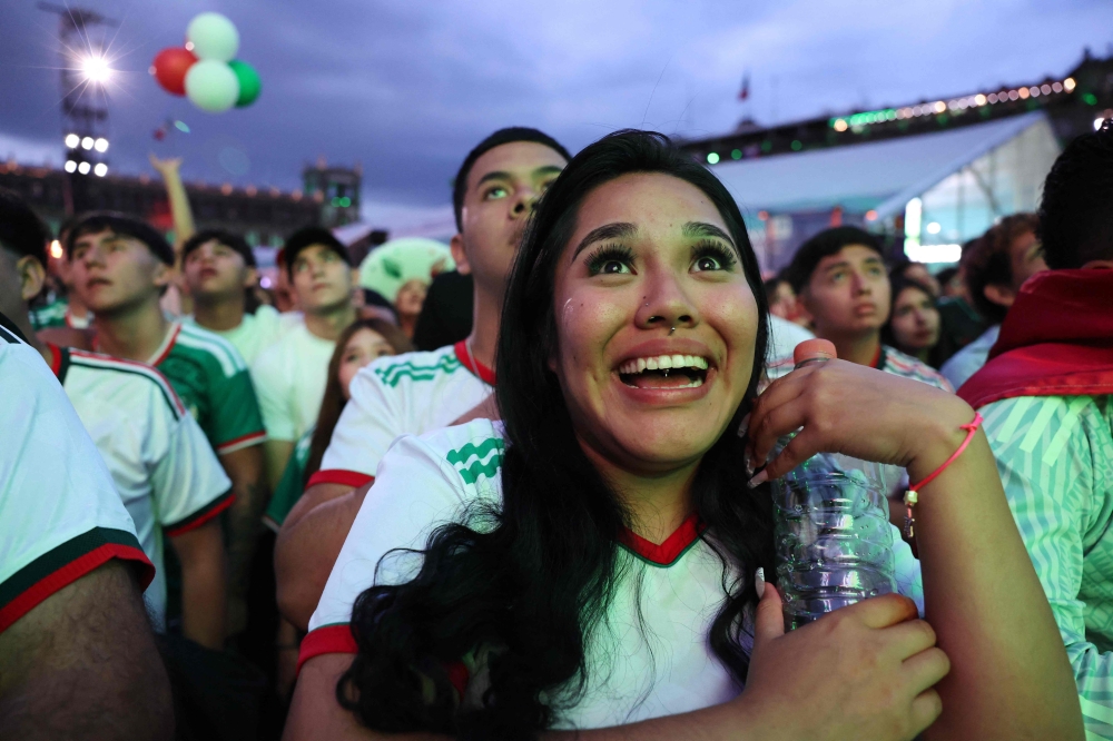 A Mexican football fan reacts as she watches a live broadcast of the 2026 FIFA World Cup football match between Mexico and Czechia at the FIFA Fan Fest in Mexico City 