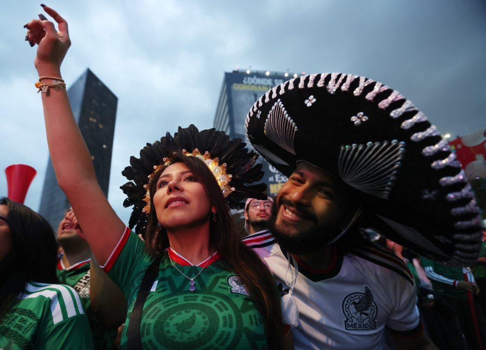  
Mexico fans react as they watch the match  