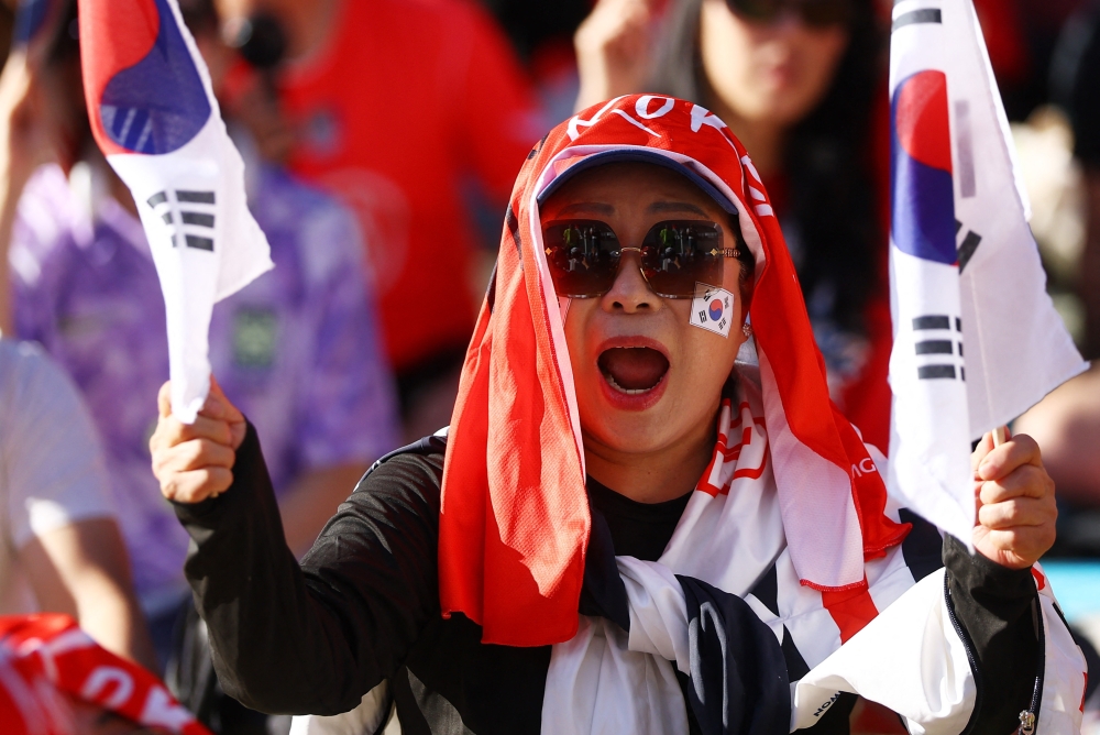  
A South Korea fan reacts as they gather to watch the match in Los Angeles  