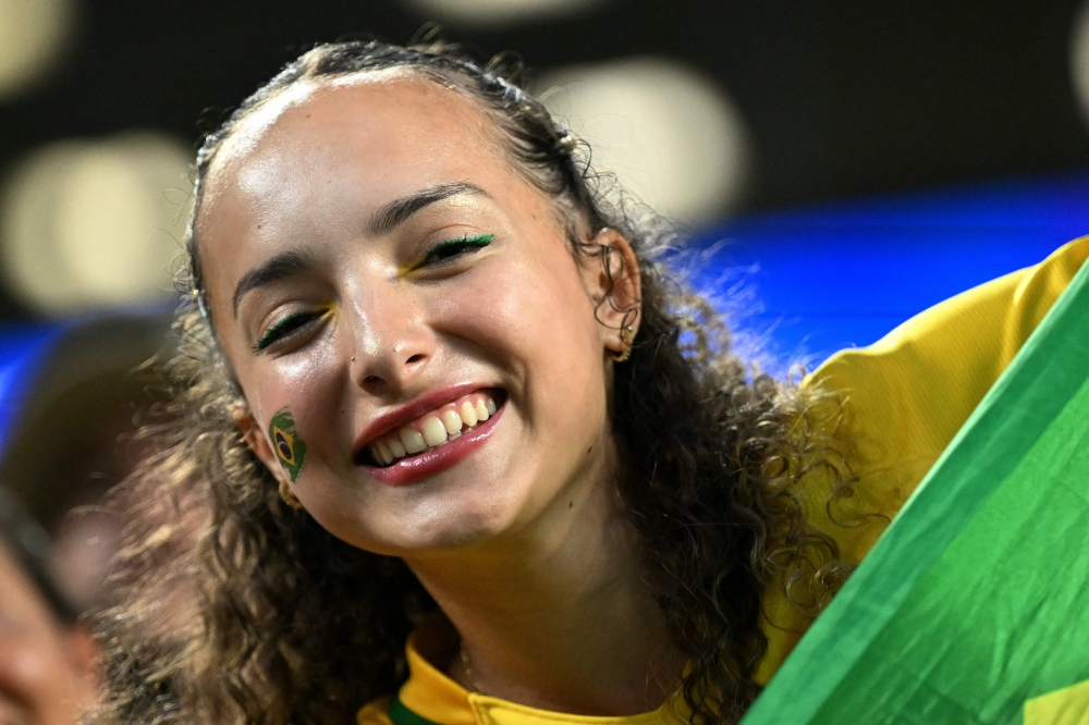 A Brazilian fan smiles after winning the 2026 World Cup Group C football match between Scotland and Brazil at the Miami Stadium
