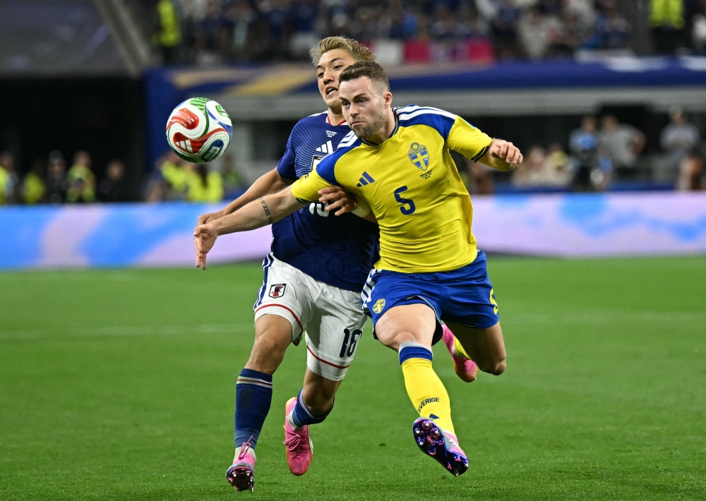 Japan's #10  Doan and Sweden's #05 Gudmundsson. — AFP