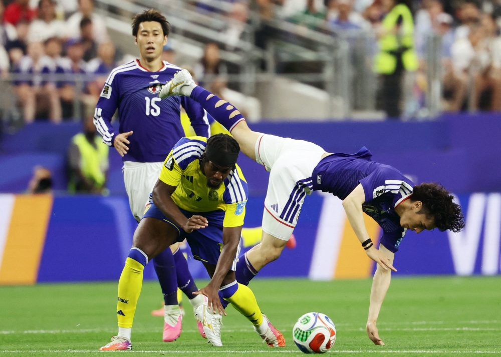 Japan's #07 Tanaka is fouled by Sweden's #11 Elanga. — AFP
