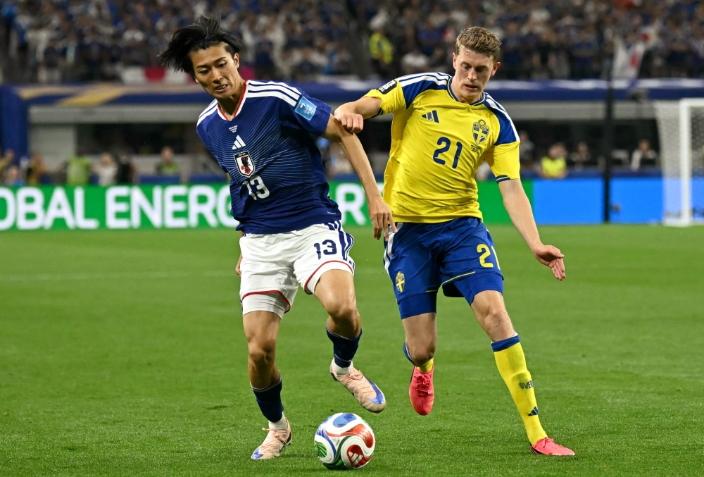 Japan's #13 Nakamura and Sweden's #21 Bernhardsson. — AFP 