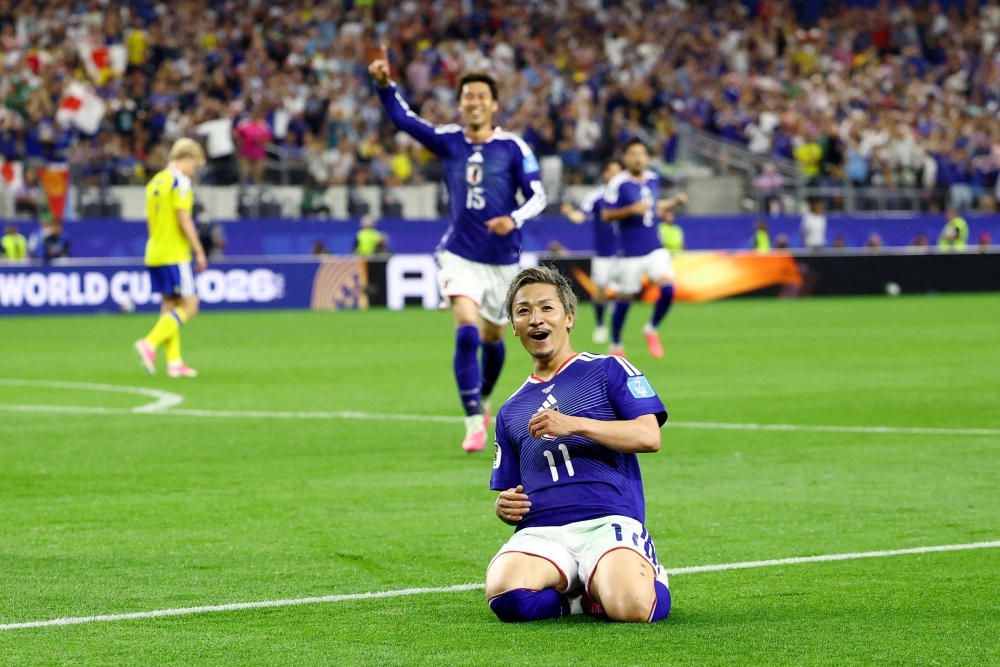  
Japan's Daizen Maeda celebrates scoring their first goal. — Reuters