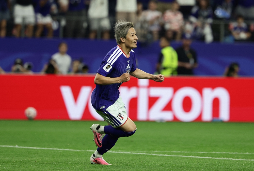 Japan's  #11 Daizen Maeda celebrates scoring first goal. — AFP