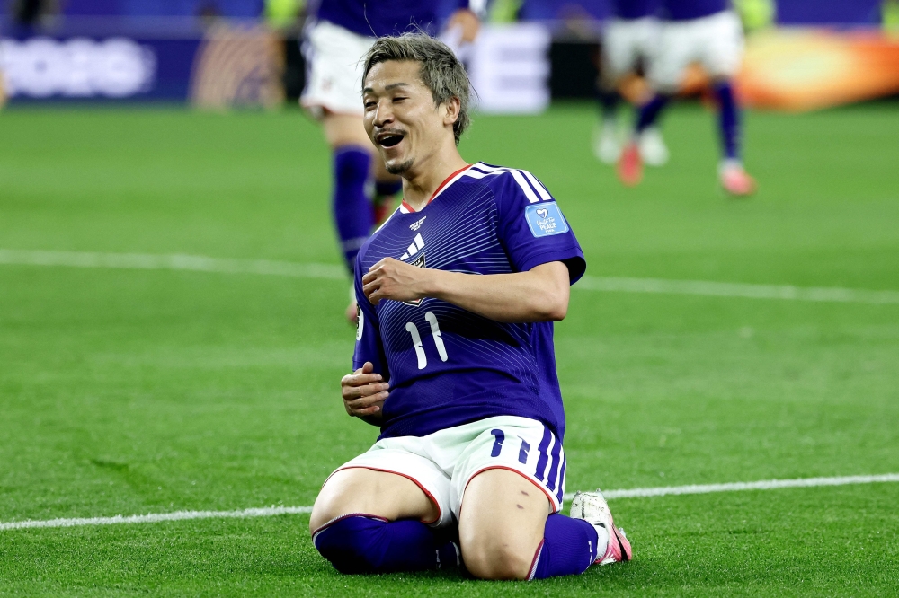 Japan's #11 Maeda celebrates scoring first goal. — AFP
