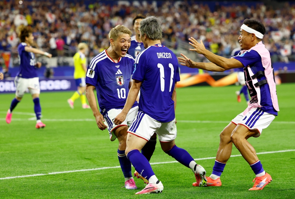  
Japan's Maeda celebrates scoring first goal with Doan and Nagatomo. — Reuters