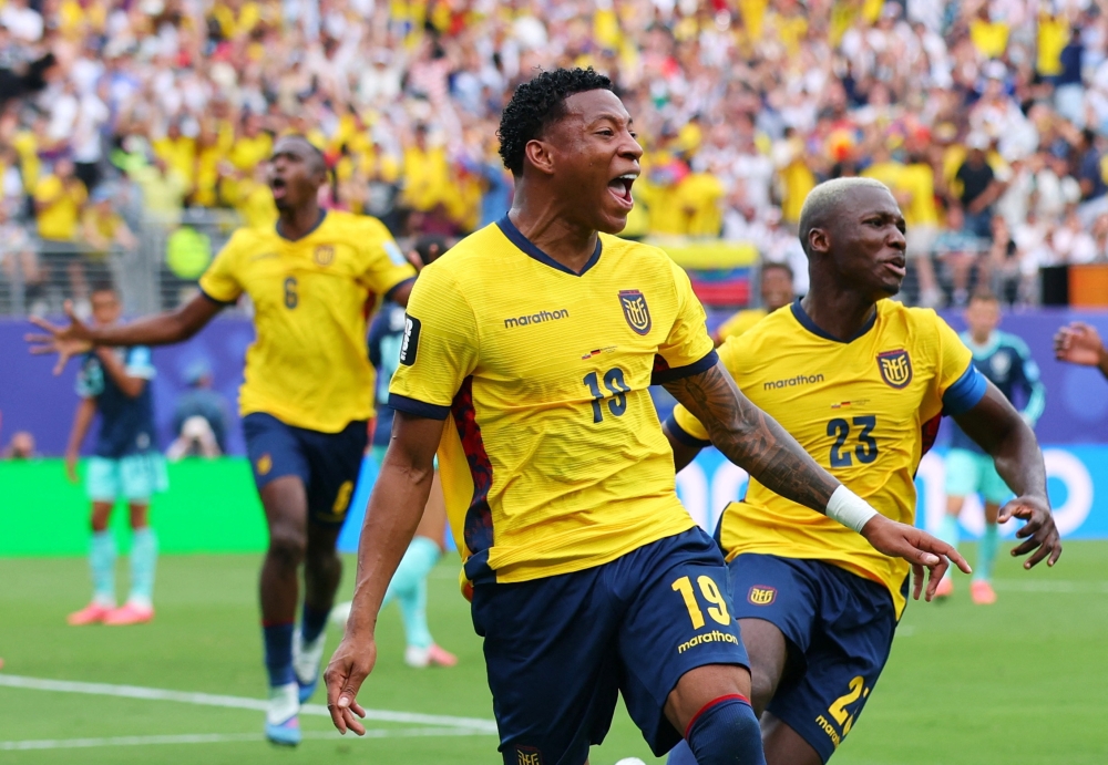  
Ecuador's Gonzalo celebrates scoring second goal with Moises. — Reuters 