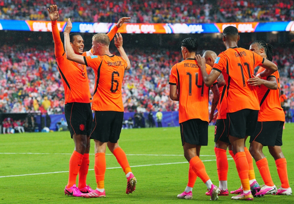  
Netherlands' Jan Paul van Hecke celebrates scoring goal with teammate. — Reuters