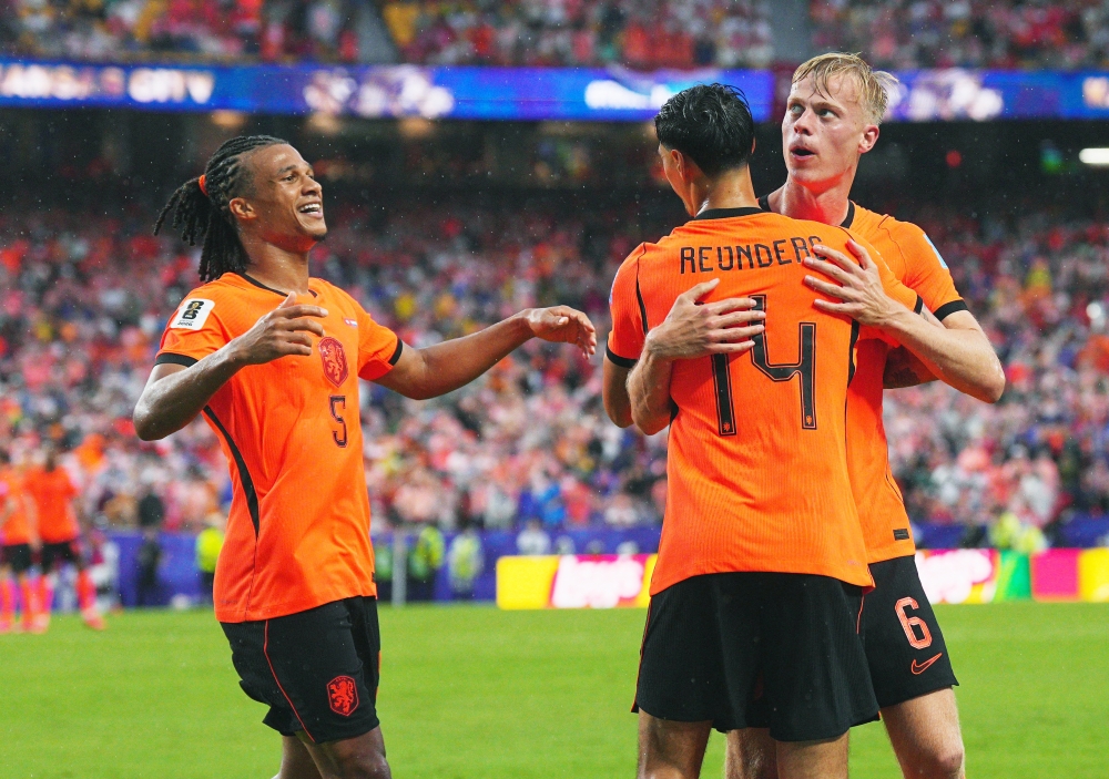  
Netherlands' Jan Paul van Hecke celebrates scoring goal with teammate. — Reuters