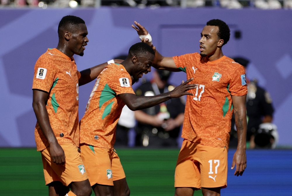  
Ivory Coast's Nicolas celebrates scoring second goal with Guela and Ange. — Reuters 