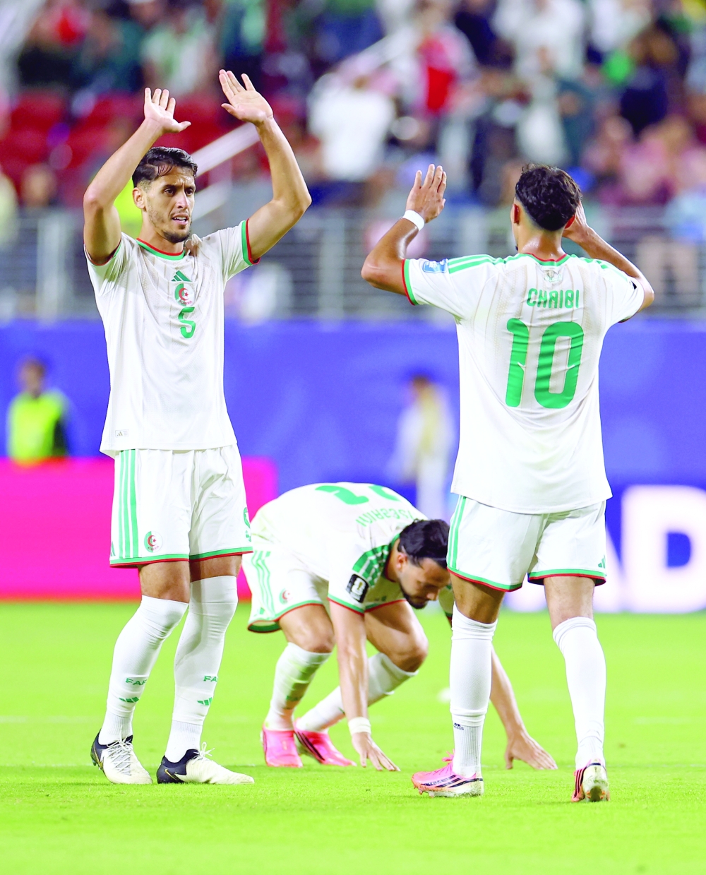  
Algeria's Zineddine Belaid and Fares Chaibi celebrate after the match  