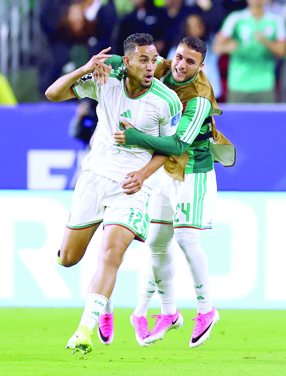  
Algeria's Nadhir Benbouali celebrates scoring their first goal with Yassine Titraoui  