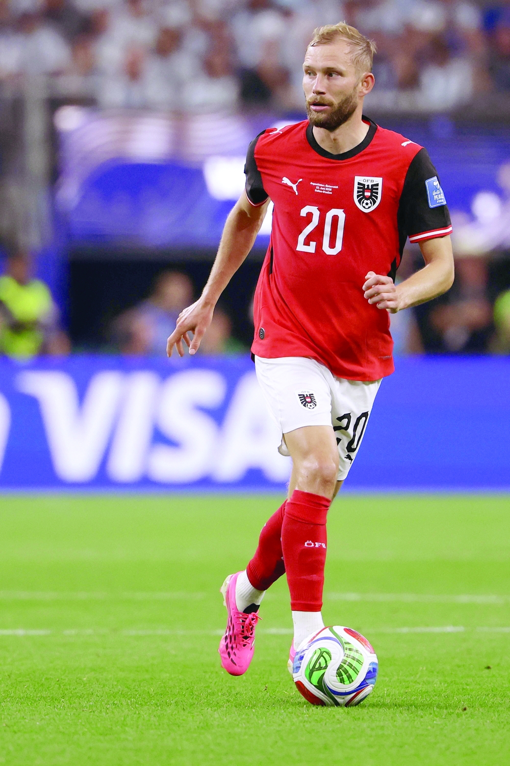Austria's midfielder #20 Konrad Laimer runs with the ball  