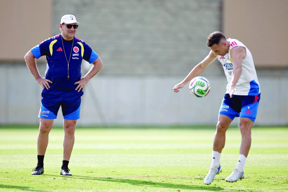 Colombia's head coach Lorenzo and d #04 Santiago during training. — AFP