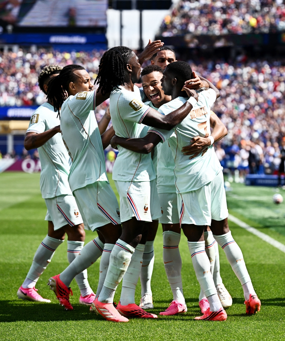  
France's Dembele celebrates third goal with teammates. — Reuters