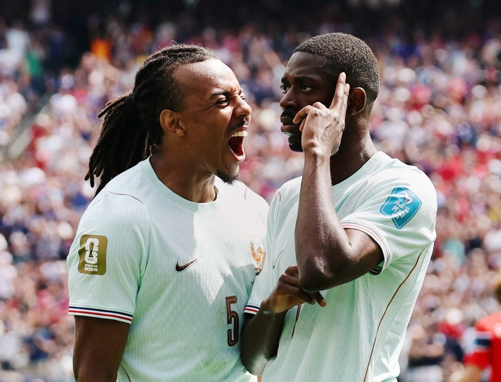  
France's Dembele celebrates scoring first goal with Jules Kounde. — Reuters