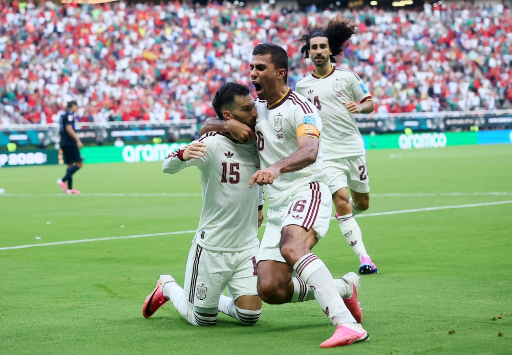Spain's #15 Baena celebrates scoring  first goal with Marc and Rodri. — Reuters