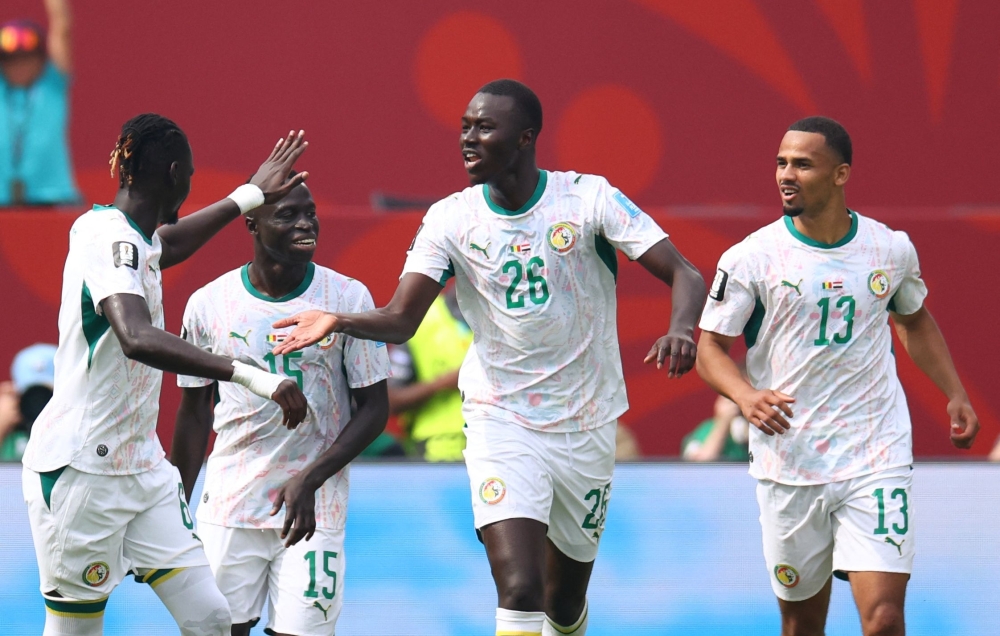 Senegal's #26 Gueye celebrates with teammates. — AFP 