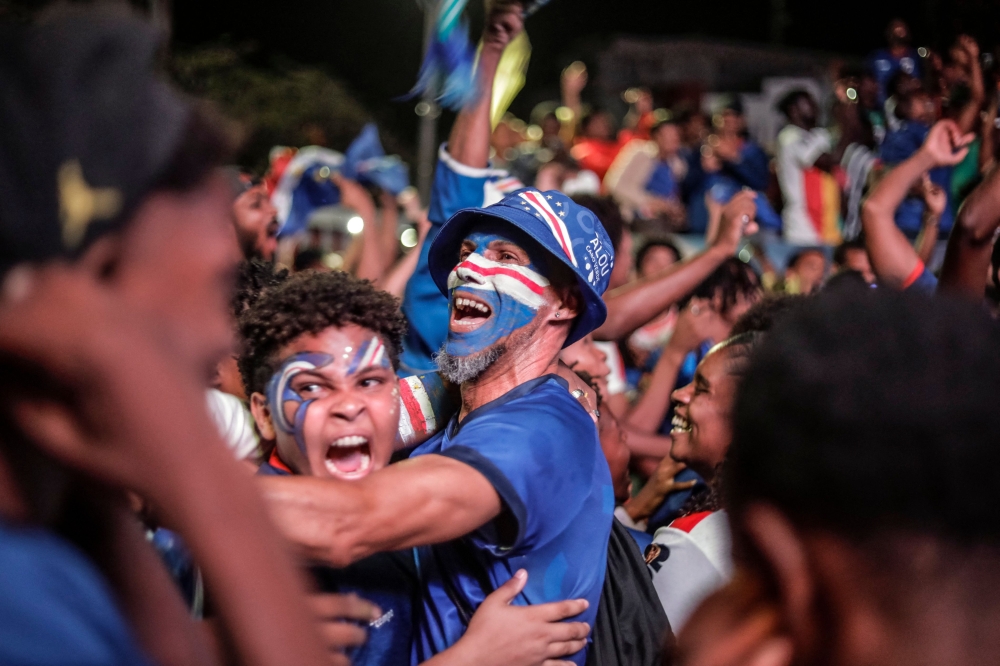 Supporters of Cape Verde's national football team celebrate after their team qualified for the knockout stage of the 2026 World Cup in Praia 
