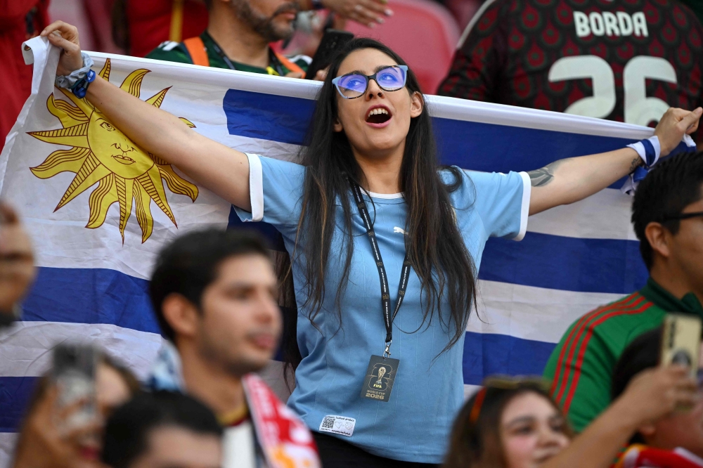 An Uruguayan fan holds a national flag ahead of the 2026 World Cup Group H football match between Uruguay and Spain at the Guadalajara Stadium  
