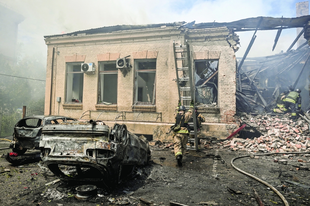 Firefighters work at the site of a Russian military strike in Zaporizhzhia, Ukraine. — Reuters 