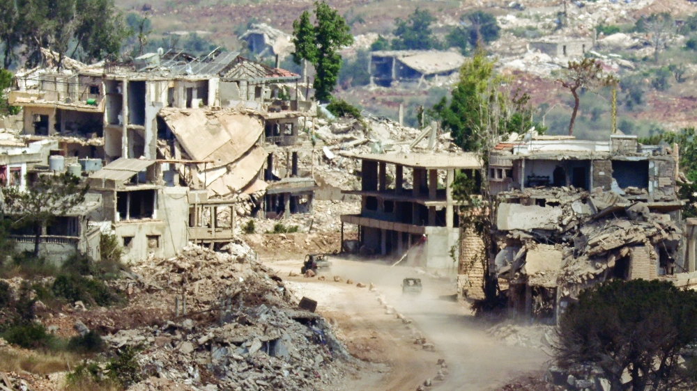 Israeli military vehicles drive amid destroyed buildings in Lebanon. — Reuters