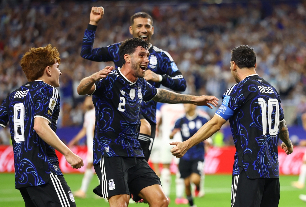  
Argentina's Messi celebrates scoring third goal with Senesi and Barco. — Reuters  