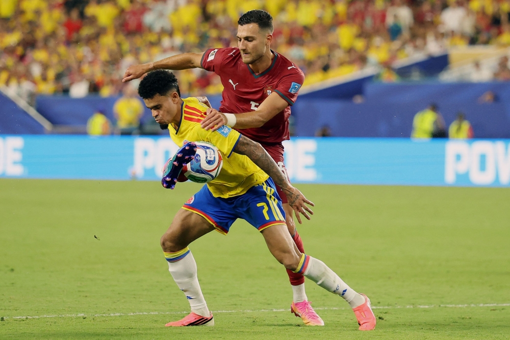 Colombia's #07 Diaz and Portugal's  #05 Dalot fight for the ball. — Reuters 