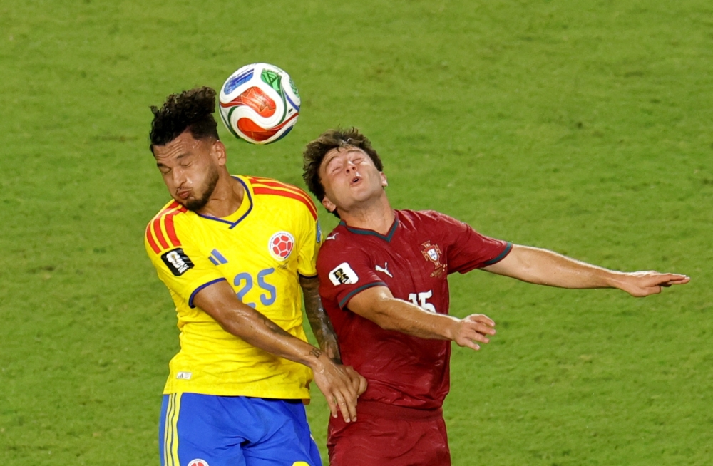  
Portugal's Neves in action with Colombia's Suarez. — Reuters
