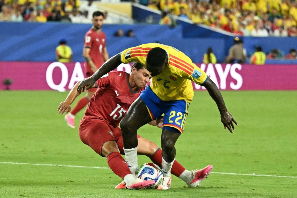 Portugal's #15 Neves and Colombia's #22 Machado fight for the ball. — Reuters  