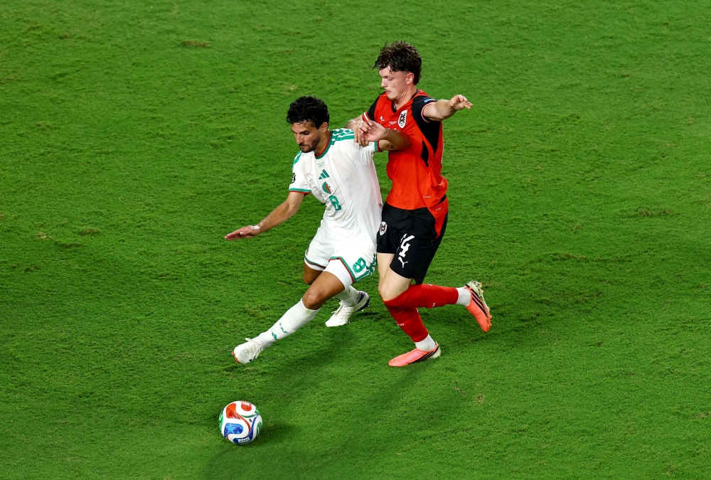  
Austria's Wanner in action with Algeria's Aouar. — Reuters