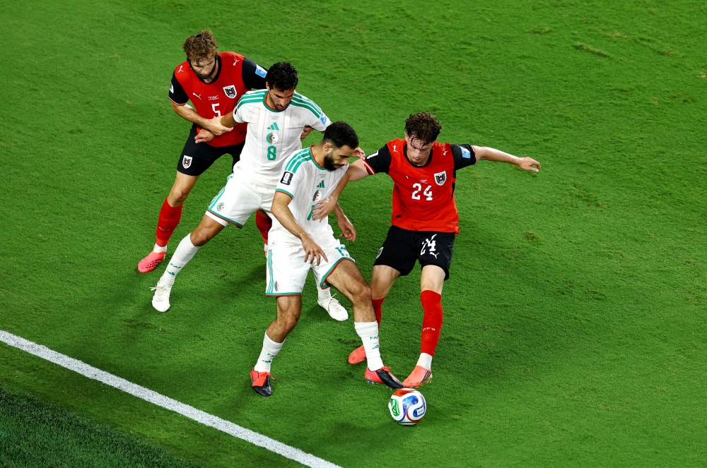  
Austria's Wanner in action with Algeria's Ait Nouri. — Reuters 