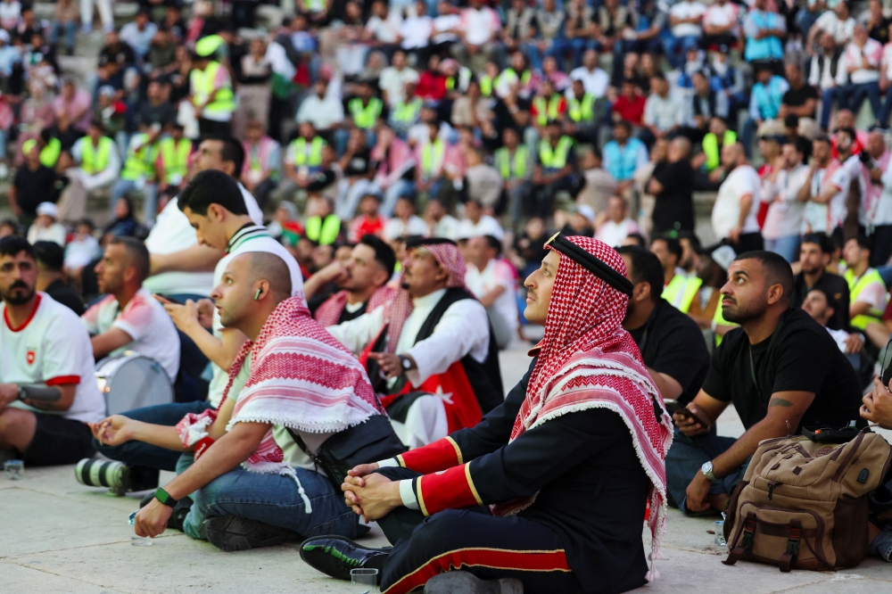 Jordanian fans watch the FIFA World Cup 2026 match between Jordan and Argentina on a screen at the Roman Theatre in Amman 
