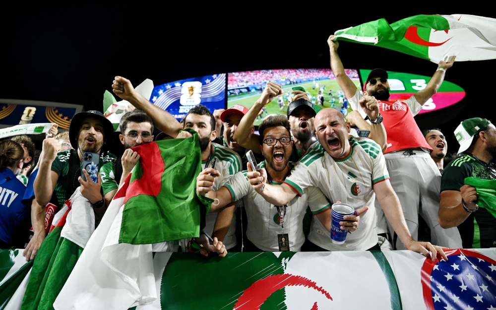  
Algeria fans celebrate after the match as Algeria qualify for the knockout stages of the World Cup  