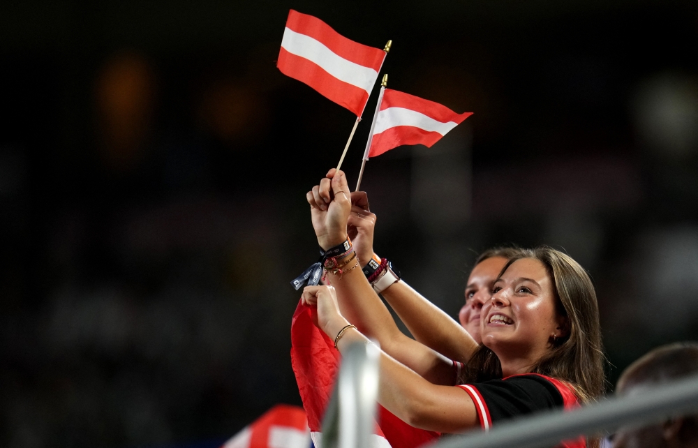  
Fans wave flags of Austria in the stands  