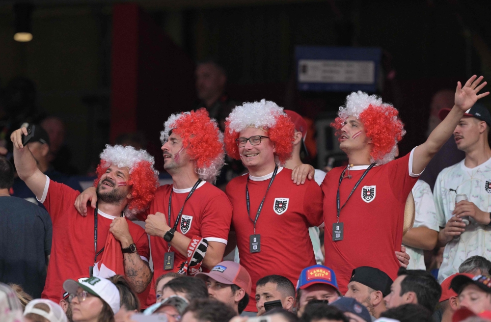  
Fans wave flags of Austria in the stands  