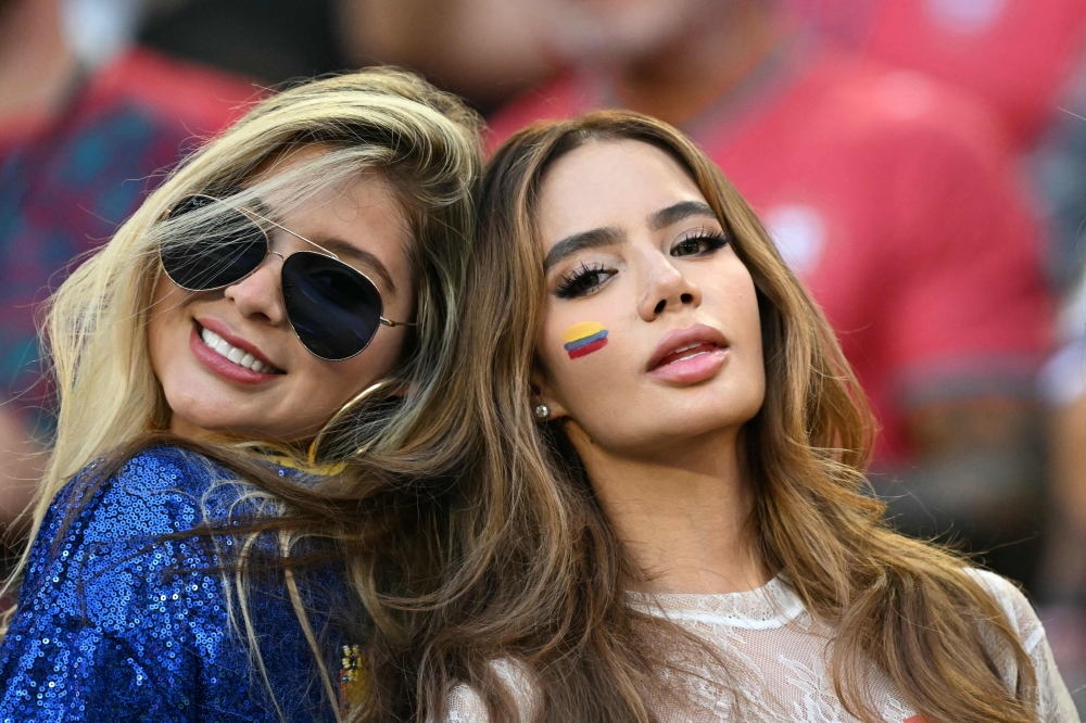 Colombian fans pose for a photo during the 2026 World Cup Group K football match between Colombia and Portugal at the Miami Stadium in Miami Gardens 