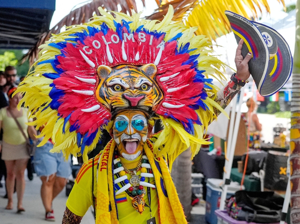  
A Colombia fan wears a tiger costume as fans gather to watch the match at Tardes Calenas Bar Restaurant in Hollywood   
