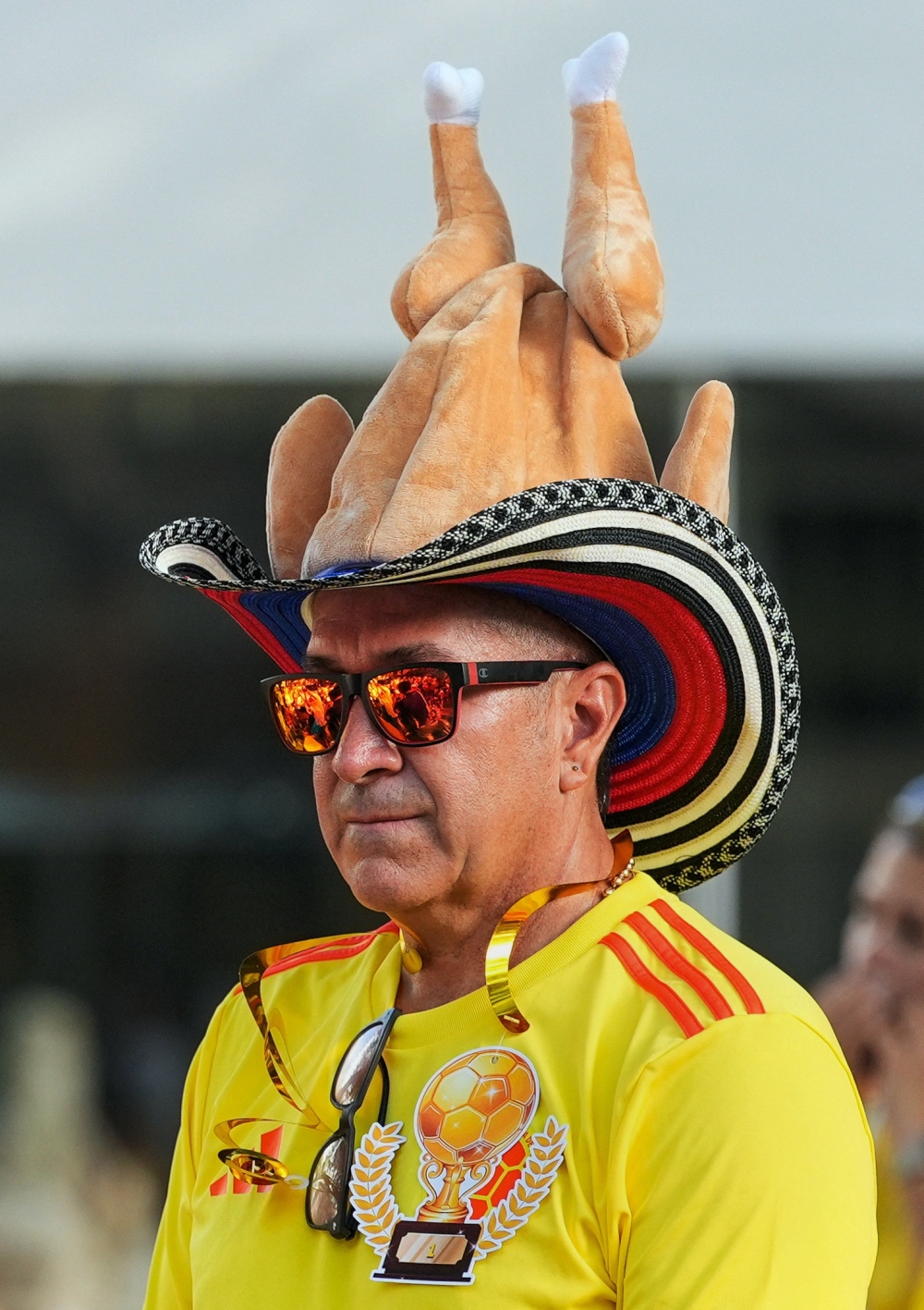  
A Colombia fan wears a chicken-themed hat as fans gather to watch the match at Tardes Calenas Bar Restaurant in Hollywood