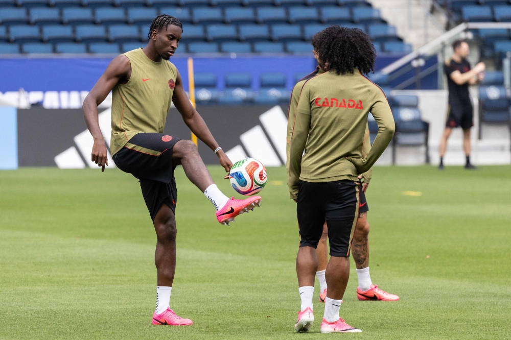Moise Canada's defender #15 Moise Bombito (L). — Reuters  